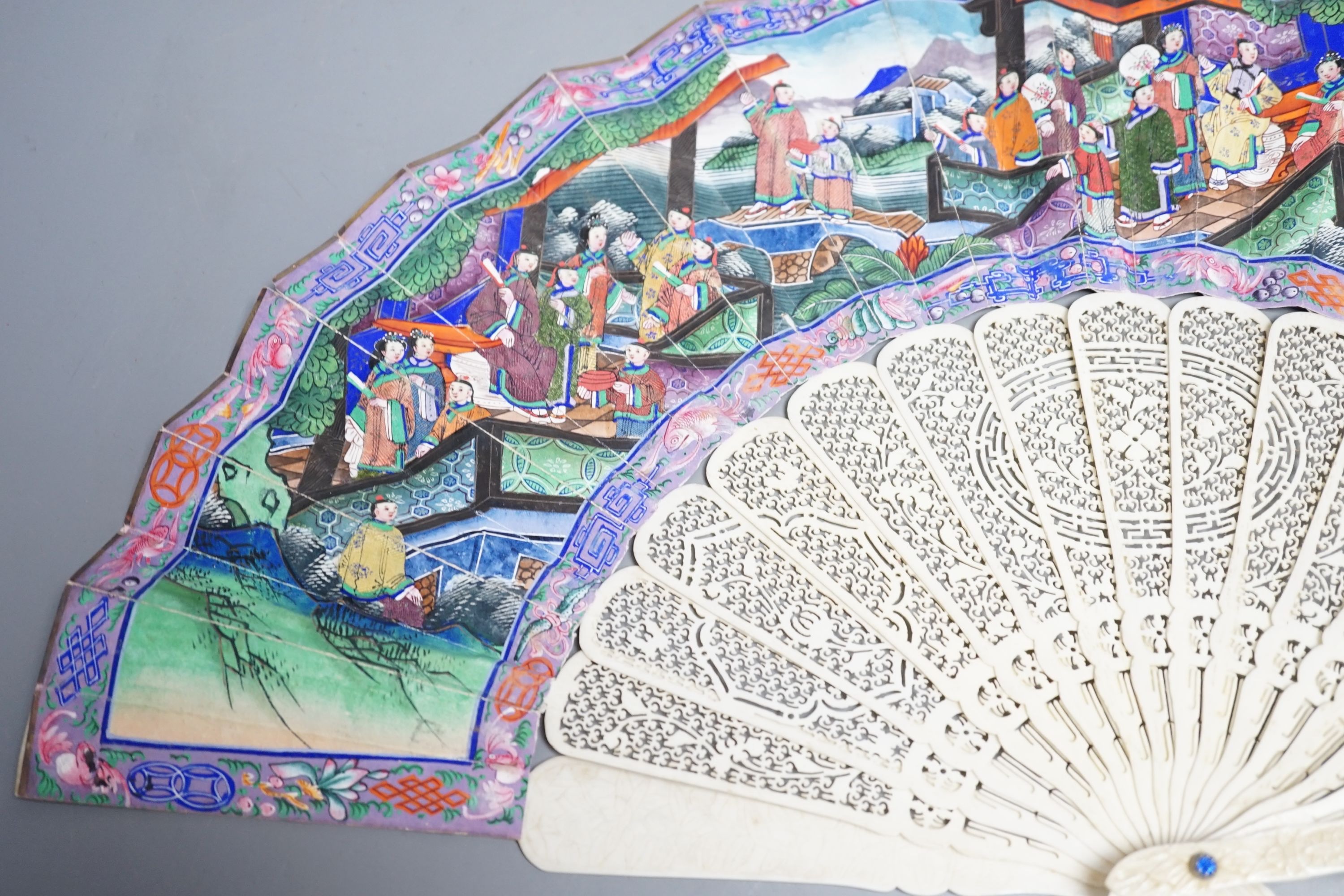 A 19th century Chinese export pierced ivory and painted paper leaf fan. 28cm long